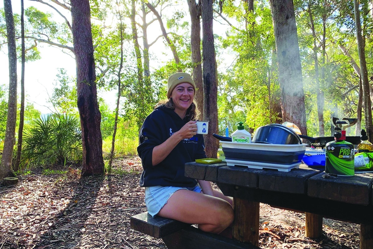 Locum optometrist Alinta Southam-Rogers having a cuppa after setting up camp on Fraser Island, August 2021.
